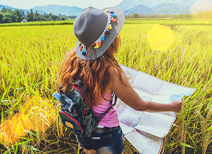 Planning Your Trip_Home News_Guides and Maps-Woman in field with map